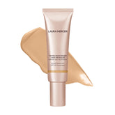 Laura Mercier Tinted Moisturizer Light Revealer bottle with pearl blends for radiant glow.