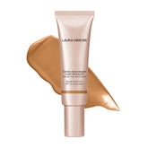 Laura Mercier Tinted Moisturizer Light Revealer with pearls for a natural glow.