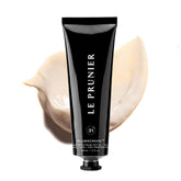 Le Prunier Plumscreen bottle closeup showing mineral sunscreen with Plum Superfruit Complex for antioxidant protection.
