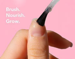 Liaison UltraGrow brush applying thin layer to nails for conditioning
