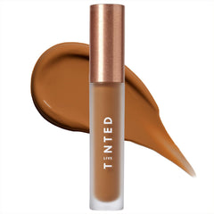 Live Tinted Hueskin Serum Concealer application with fingers for buildable coverage.