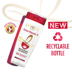 Lathering L'Oreal Paris Total Repair 5 shampoo on hair for smooth cleansing.