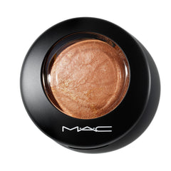 MAC Mineralize Skinfinish Global Glow swatch on the cheek shows subtle toasted glow