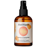 Mad Hippie Vitamin C Toning Mist bottle glows with a brightening glow.