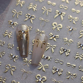 Maigitur 5D embossed gold bow nail stickers with rhinestones for a luxurious spring manicure