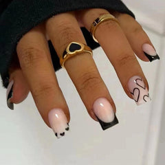 Maigitur French Tip press-on nails with black base and white heart design for effortless V-day style