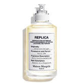 Maison Margiela Replica Afternoon Delight bottle highlights a warm gourmand fragrance for cozy evenings.