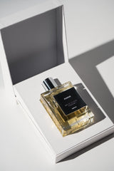 Maktoob Kudos Parfum bottle highlighting its golden hue for premium appeal.