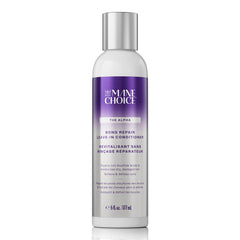 The Mane Choice Alpha Recoil Leave-In bottle pouring onto damp curls for hydration
