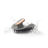 MANTA Pulse electric scalp massage brush showing palm-molded design for comfortable grip.