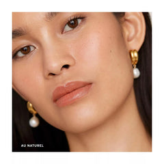 Close-up of Merit lip oil application with glossy, lightweight finish