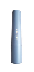 Merit Minimalist Foundation Stick in Umber, swirled on cheek for natural coverage.