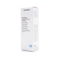 Mesoestetic Tricology bottle viewed up close, supports scalp care and fuller-looking hair.