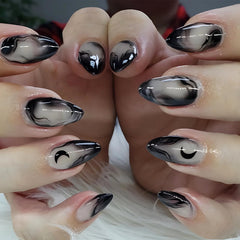 MISUD press-on nails in medium almond shape with gothic black ombre and moon motif for stylish DIY manicure.