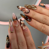 Mivota almond brown nails with 3D flowers for an elegant autumn look.