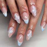 Mivota blue French tip almond nails with butterfly accents for a romantic look.