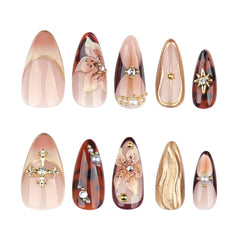 Mivota gold charms add sophistication to party-ready fake nails.