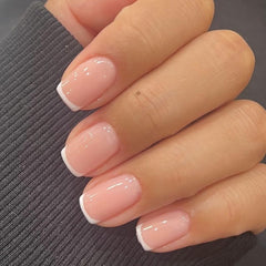 Modelones extra short press on nails in white packaging showing ready-to-wear elegance.