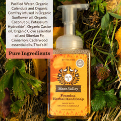 Moon Valley Organics By the Fire bottle pour demonstrating foam texture and cleansing