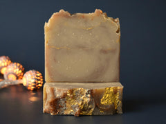 Sidelong view of vegan soap bar highlighting gold glitter for a radiant daily cleanse.