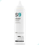 NAPURA S9 shampoo bottle on a shower shelf, color-safe care for damaged hair.