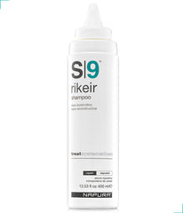 NAPURA S9 shampoo bottle on a shower shelf, color-safe care for damaged hair.