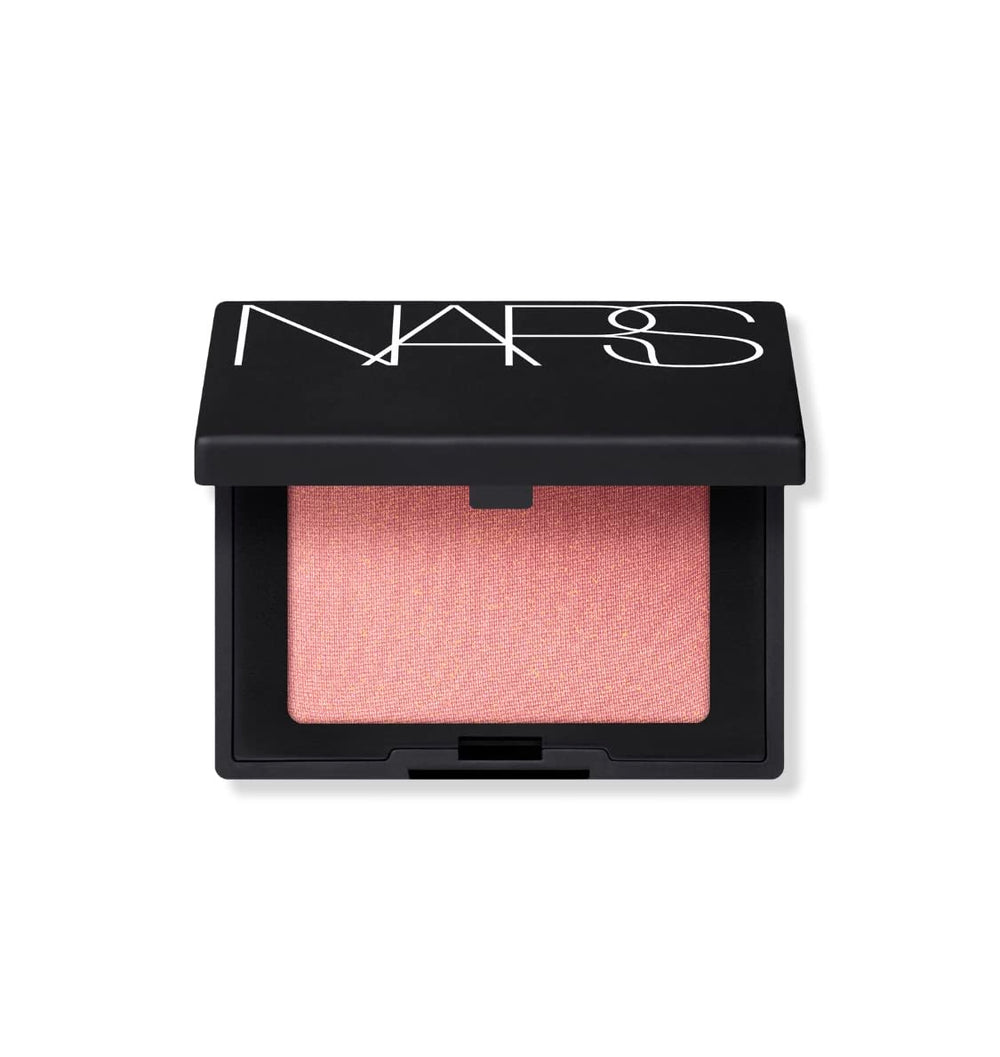 NARS Orgasm powder blush mini travel size in peachy-pink shade with golden shimmer for radiant flush.