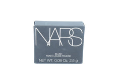 NARS Orgasm X application technique demonstrating buildable color on cheeks.