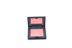 NARS Orgasm X travel-size compact powder for on-the-go radiant color and touch-ups.