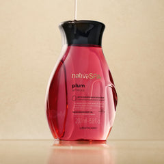 NATIVA SPA Plum Body Oil being poured to show quick absorption.