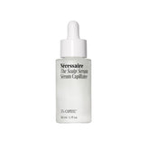 Nécessaire Scalp Serum pipette dispensing on a glass bottle for precise application on the scalp.