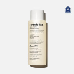 Nécessaire shampoo foam close-up showing gentle lather.
