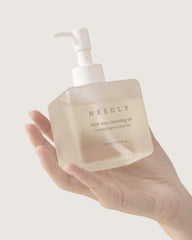 Needly Cleansing Oil texture on skin showing smooth cleansing action.