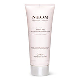 Neom Great Day Magnesium Body Butter bottle glows with uplifting, zesty mandarin and peppermint scent.