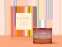 Nicole Miller Nectar De Peche bottle on display, emphasizing a romantic summer scent.