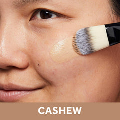 No7 Lift & Luminate foundation on skin during application shows creamy texture and seamless blend.