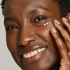 No7 Lift & Luminate cream being dispensed for gentle under-eye application.