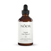 NOOR HAIR Growth Serum bottle close-up showing growth-supporting formula.