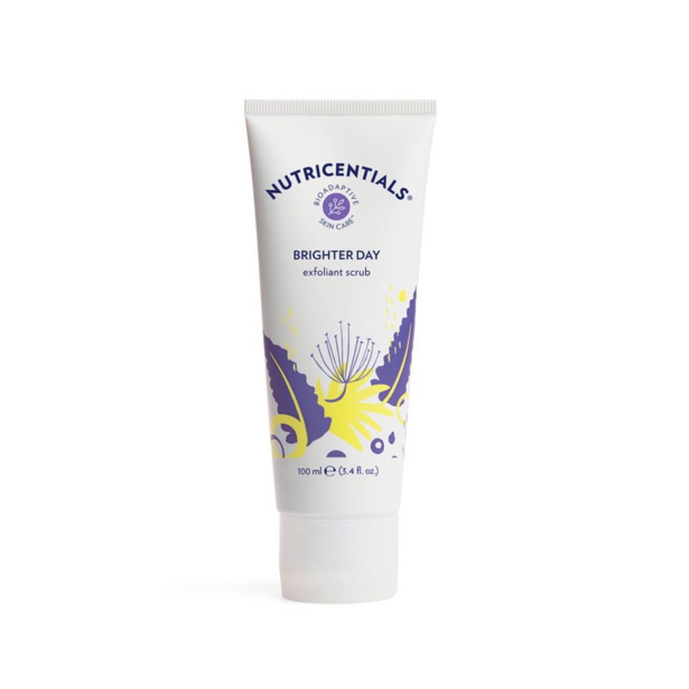 Nu Skin Brighter Day Exfoliant Scrub with pomegranate enzymes on a spa surface for a gentle glow.
