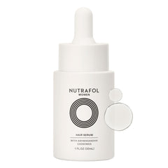 Nutrafol Women's Hair Serum bottle on a clean surface for daily scalp nourishment.