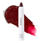 Ogee Dahlia lip oil bottle shows burgundy tint with nourishing oils.