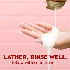 OGX bottle highlights caffeine and coconut oil for hair nourishment and strength.