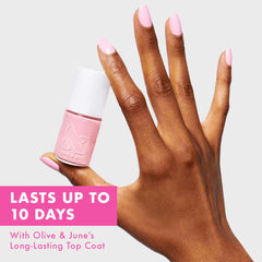 Olive & June wide brush applying polish for smooth, streak-free coverage.