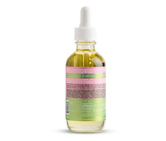 Applying ORS Curlshow oil to scalp for moisture and irritation relief