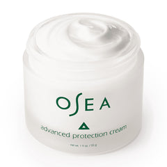 Hands applying OSEA Advanced Protection Face Cream, ready for daily use.
