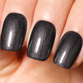 Ozzeal Pearl Gel Polish black glitter bottle close up for elegant long-lasting nail sparkle.