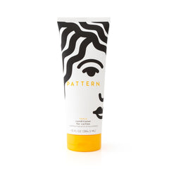 PATTERN Heavy Conditioner bottle on shelf for rich hydration and detangling.