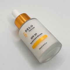On-face view of PELO Naturals SPF 50 Serum with dewy glow and no heavy cast.