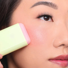 Pixi On-the-Glow Blush application with fingertips for natural blending.