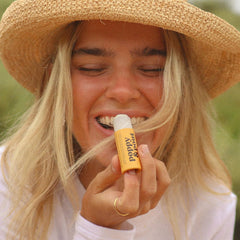 Ingredients list emphasizes organic coconut oil and USA-sourced beeswax for moisturizing lips.